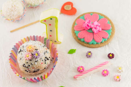 First birthday celebration preparation with small cake and candle