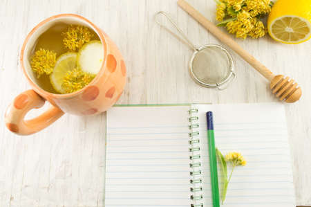 Linden Tea with fresh flowers and lemon servedの写真素材