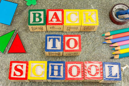 Back to school written with wooden letters and learning toolsの写真素材