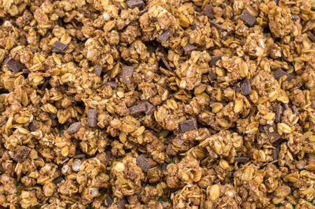 Healthy granola muesli cereals with chocolate pieces backgroundの写真素材