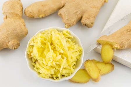 Raw ginger root, whole, sliced and chopped
