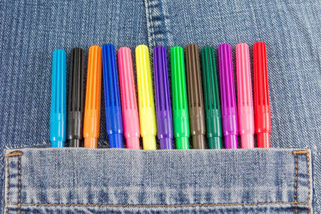 Colorful crayons in denim blue jeans pocketの写真素材
