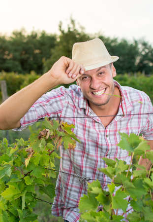 Happy young farm owner at the vineyardの写真素材