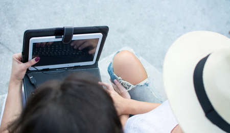 Two friends looking at the tablet device outsideの写真素材