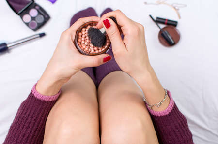 Point of view of a woman using makeup in bedの写真素材
