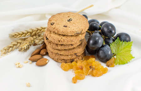 Integral cookies with grapes and almonds on white