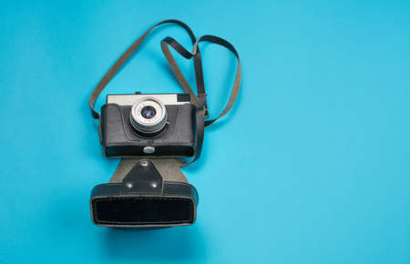 good old film camera on blue background