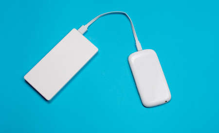 White phone charging from a power bank