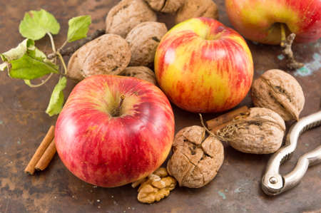 Apples, walnuts and nuts cracker on a table