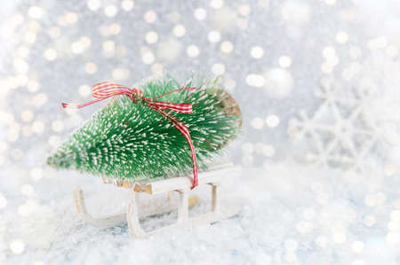 Small sleigh carrying a toy  Christmas treeの写真素材