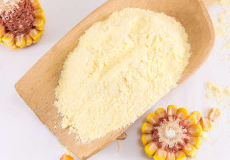 corn flour and corn on a wooden table