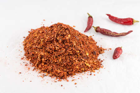 Ground red pepper and dried peppers closeup