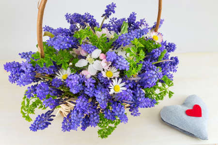 Bluebell flowers bouquet in a wicker basketの写真素材