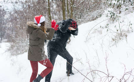 Crazy couple in snow fight on a snowy dayの写真素材