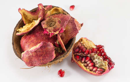 Pomegranate and dried fruit skin on white backgroundの写真素材