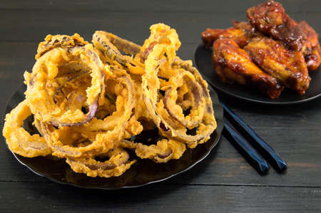 homemade onion rings with chopsticks and bbq chicken wings