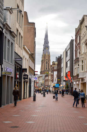 Eindhoven, the Netherlands - 15.09.2015: City center walking area view with The Sacred Heart Church rising above with few people passing buyのeditorial素材