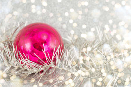 red ball and Christmas wreath on a tinsel backrgoundの写真素材