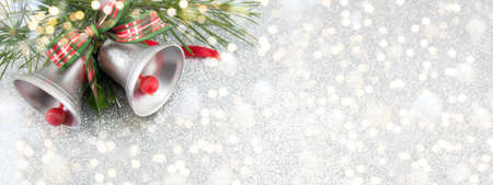 Two Christmas bells decoration with festive backgroundの写真素材
