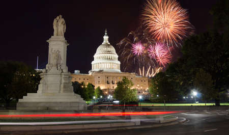 Fireworks rising over Capitol Hill and the peace monumentの写真素材