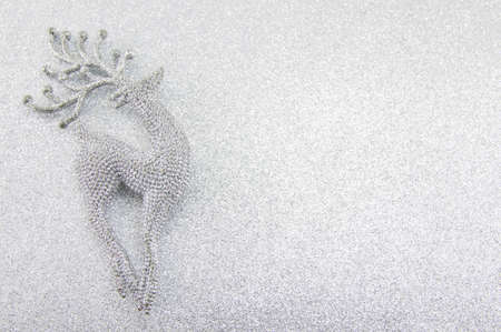 Silver reindeer toy on festive shiny backgroundの写真素材