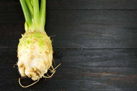 whole celery on a black table shot from close