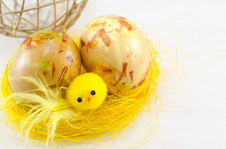 Painted Easter eggs in a yellow nestの写真素材