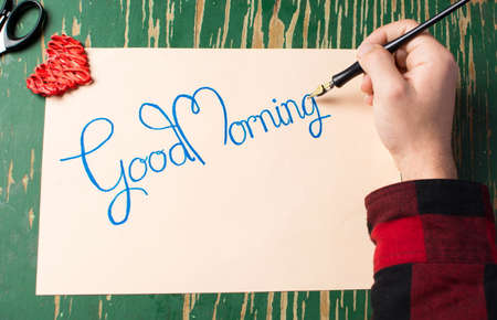 Man writing a good morning note top viewの写真素材
