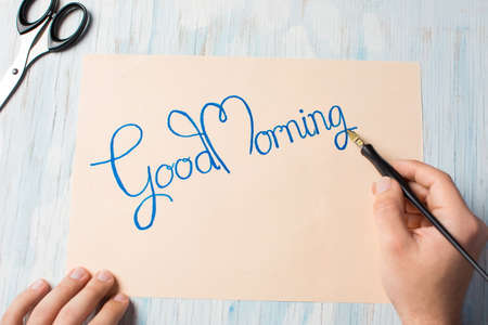 Man writing a good morning note top viewの写真素材