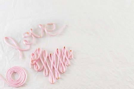 Word love made out of pink sewing threadの写真素材