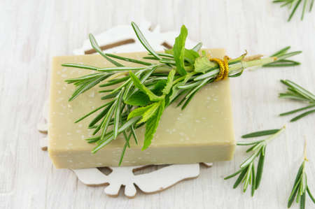 Herbal soap with rosemary and mint leaves bouquetの写真素材