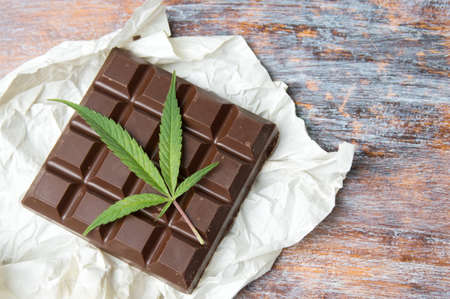 Marijuana leaves on top of dark chocolateの写真素材