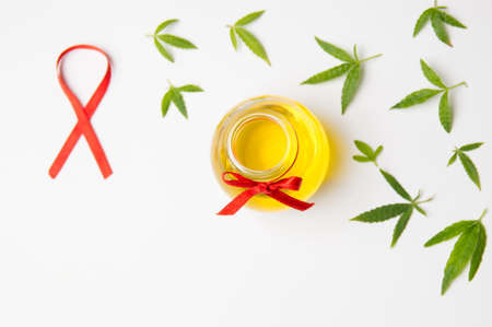 Marijuana leaves and cannabis oil on white backgroundの写真素材