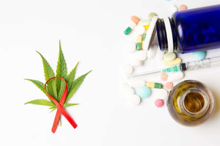 Marijuana leafs, fight cancer sign and medicaments on white backgroundの写真素材