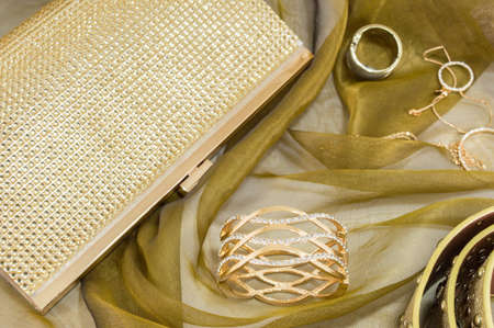 Golden colored women accessories collection on soft fabricの写真素材