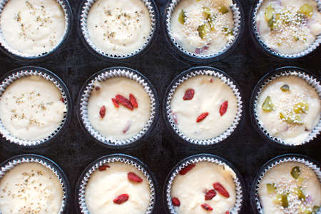 Raw muffins pastry in round paper cupsの写真素材