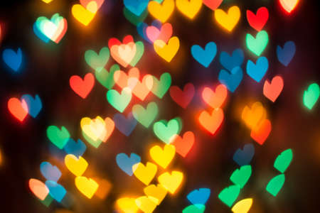 Heart shaped bokeh spread on dark backgroundの写真素材