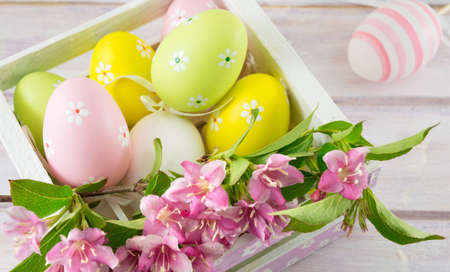 Painted Easter eggs and Japanese purple flowers