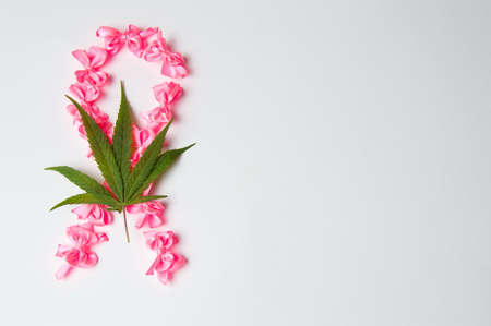 Fight cancer sign made of pink ribbons and marijuanaの写真素材