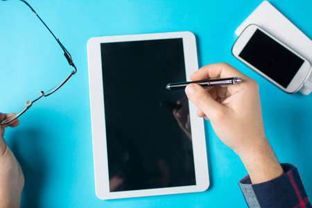 man hand a tablet device at the officeの写真素材