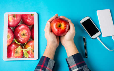 Man holding an apple. Modern agriculture abstract
