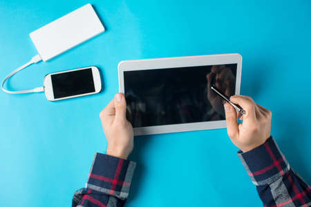 Man using a white tablet device at the office