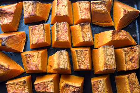 Roasted pumpkin slices on a cooking plateの写真素材