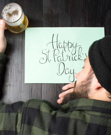 Man sleeping on a table during St Patricks day celebrationの写真素材