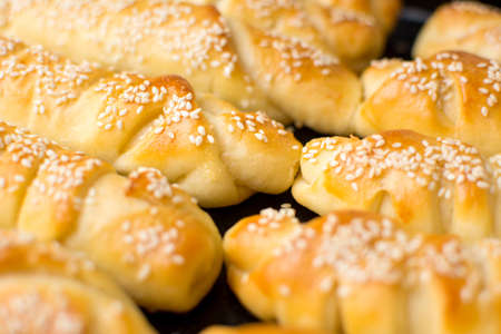 Homemade sesame pastry on black baking panの写真素材