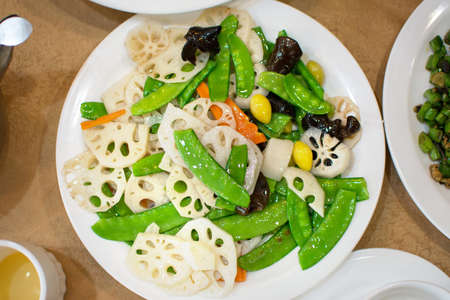 Fried lotus root with Chinese bean?garlic and raw almondsの写真素材