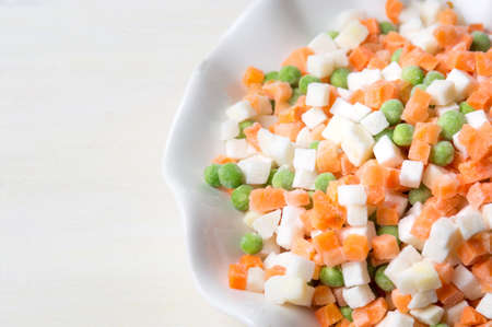Frozen vegetables on a plate for making saladの写真素材