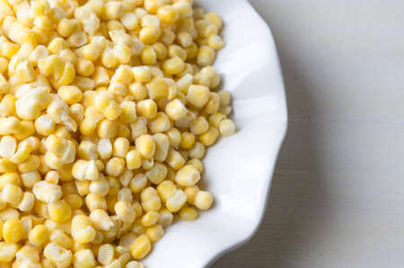 Frozen sweet corn in a bowl on a tableの写真素材