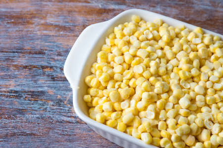 Frozen sweet corn in a bowl on a tableの写真素材