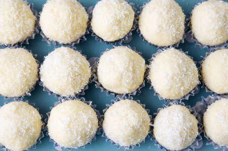 Coconut round homemade cookie balls in paper holders